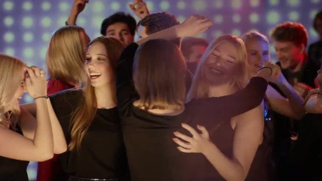 young girls at club hugging and celebrating
