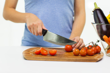 close up of woman chopping tomatoes with knife