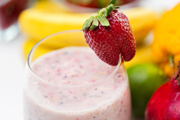 close up of glass with milk shake and fruits