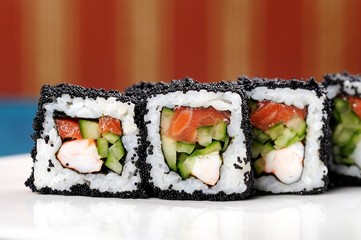 Japan square black tobiko rolls with shrimp, salmon and cucumber
