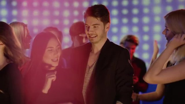 girl and guy dancing and laughing at club