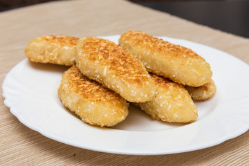 nuggets, breaded in a potato on a white plate