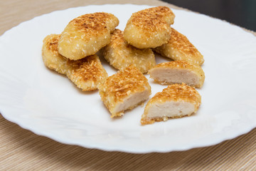 nuggets, breaded in a potato on a white plate