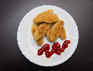 nuggets, breaded in a potato on a white plate