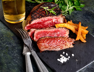 fried steak and beer on a dark background
