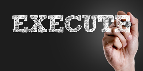 Hand writing the text: Execute