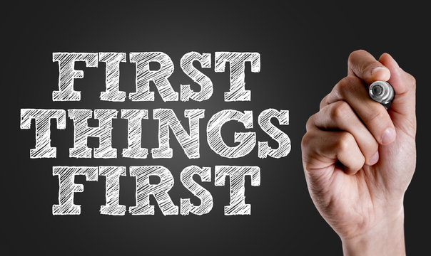 Hand writing the text: First Things First