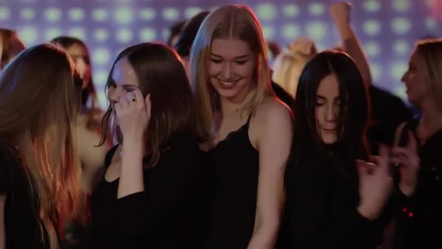 four girls dancing close to eachother at club