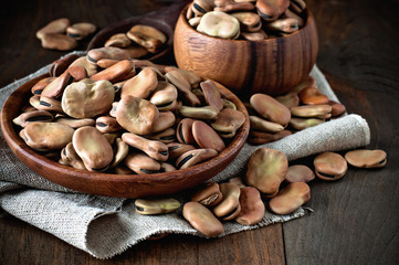 Fava beans in wooden bowls. Rustic style. Toned image. Selective focus