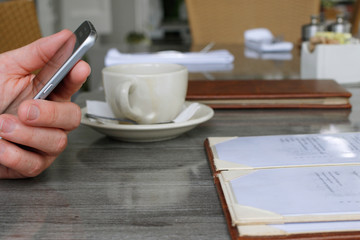 Food: Man holding phone at breakfast