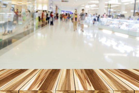 perspective wood and blurry supermarket/mall blur for background