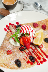 Strawberry, raspberry, blackcurrant, mint and lemon crepe served with ice cream, espresso coffee and a biscuit.