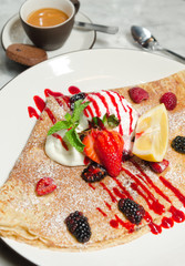 Strawberry, raspberry, blackcurrant, mint and lemon crepe served with ice cream, espresso coffee and a biscuit.
