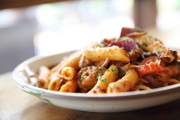 Penne pasta in tomato sauce with meatballs
