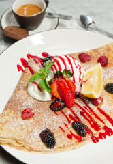 Strawberry, raspberry, blackcurrant, mint and lemon crepe served with ice cream, espresso coffee and a biscuit.