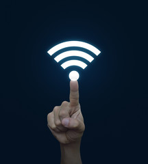 Hand pressing wi-fi button over blue background, Technology and