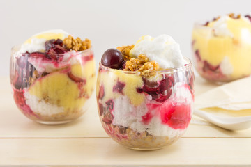 Homemade granola parfait with cherries and cream