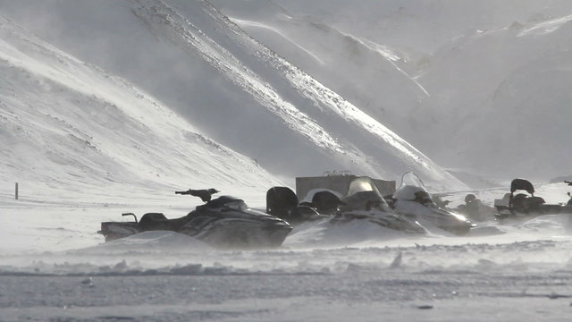 Longyearbyen, Svalbard. The snowmobiles which are swept up by snow at strong wind. A Sunny day in March.