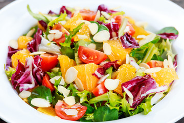 Fresh Orange, vegetables salad on white plate