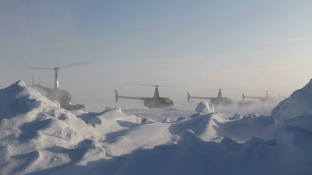 4 helicopters taking off one by one. Russian Ice Camp "BARNEO" at the North Pole. A Sunny day in March 2015
