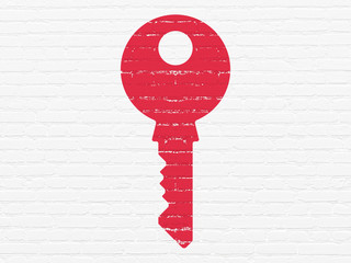 Security concept: Key on wall background