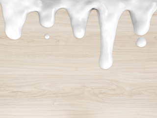 flowing cream milk on wooden background