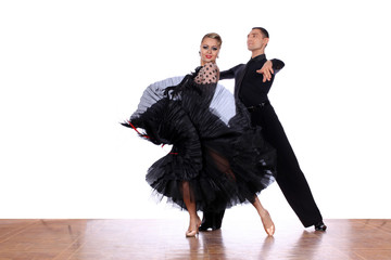 Latino dancers in ballroom against white background
