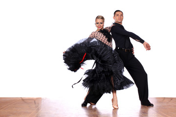 Latino dancers in ballroom against white background
