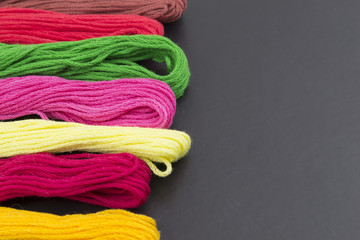 Threads for sewing on a black background
