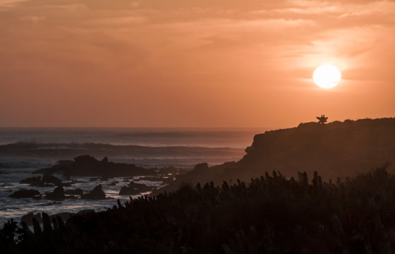Two surfers looking at the waves during sunset in Morocco