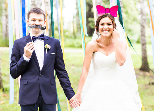 April Fools' Day. Wedding Couple Posing With Mask.