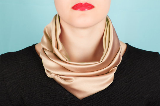 Silk Scarf. Beige Silk Scarf Around Her Neck Isolated On Blue Background.