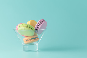 Macaroons in jar on aquamarine