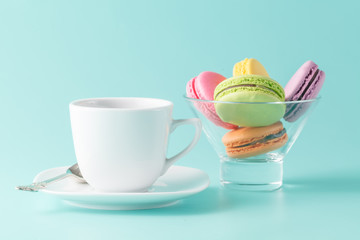 Macaroons in jar on aquamarine