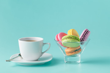 Macaroons in jar on aquamarine