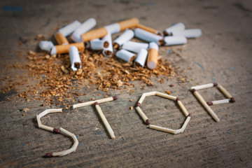 Stop smoking background with broken cigarettes - obrazy, fototapety, plakaty