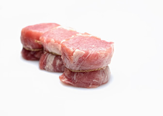 raw fillet medallions on a white background