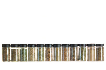 many jars with spices isolated over white