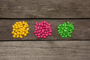 Colorful sweet candy on wooden background. Top view.