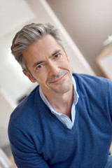 Fototapeta premium Portrait of smiling handsome man with grey hair