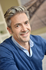 Portrait of smiling handsome man with grey hair