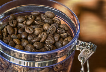 Coffee beans in glass container.