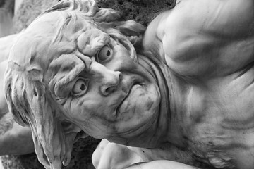 Detail of a public fountain in Vienna, Austria. The baroque statue is showing the desperation of a defeated person.