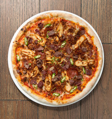 Spicy pepperoni, chicken and bacon pizza with jalape–o slices
