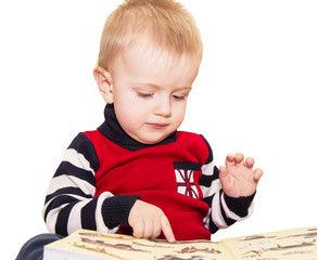 The fair-haired kid considers pictures in the book