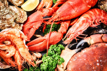Fine selection of crustacean for dinner. Lobster, crab and jumbo - obrazy, fototapety, plakaty