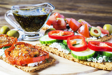 Crispbread with tomatoes, cheese, black olives, dill. Bruschetta
