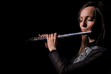 a young girl playing the flute © sushytska