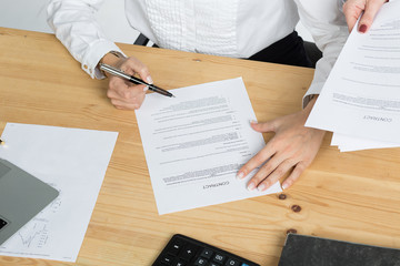 woman thinking about signing a contract