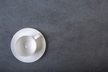 Obraz na płótnie Canvas Cup of coffee on a black wooden table background.